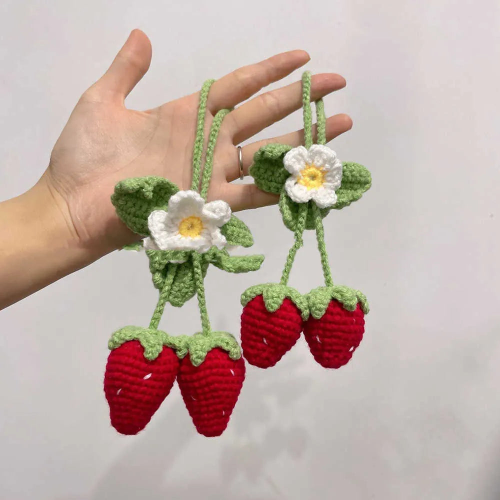 Handmade strawberry-shaped car pendant woven from cotton and hemp with natural colours