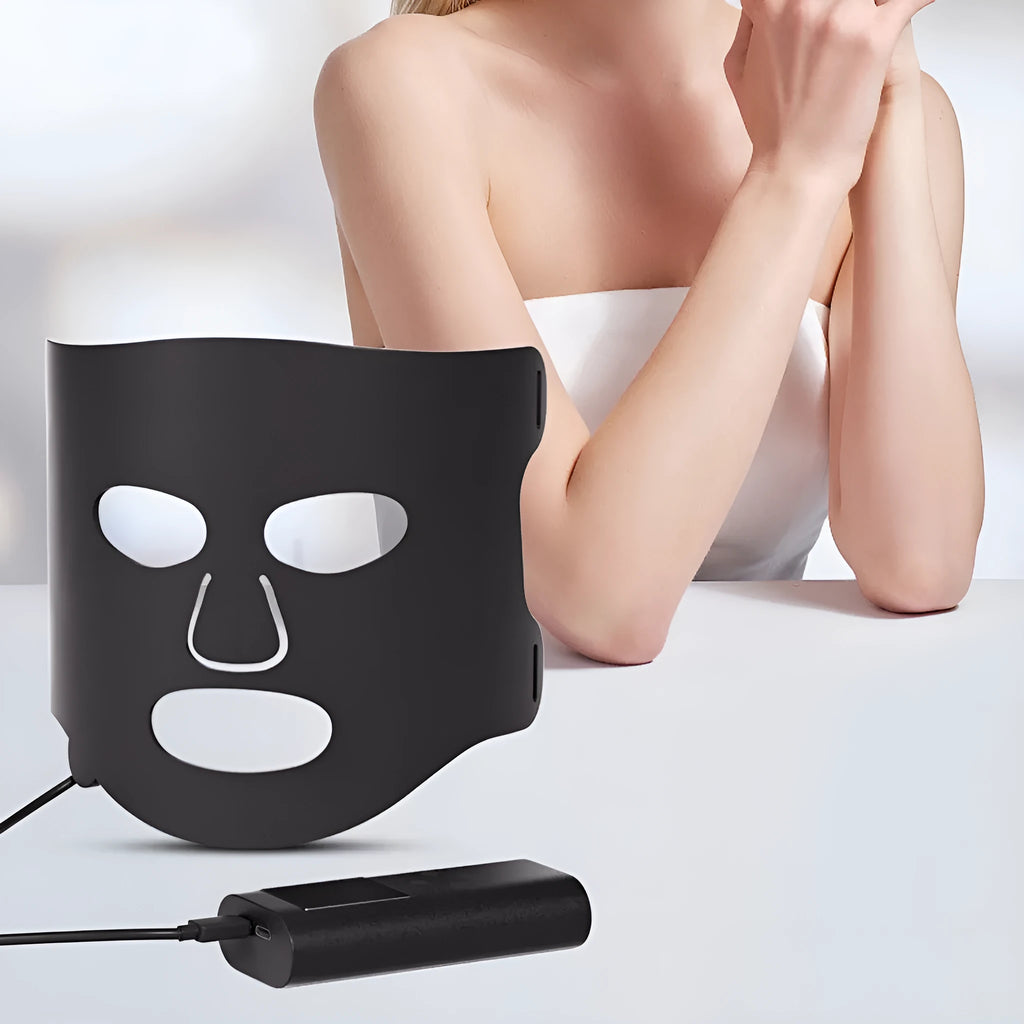 Black and white LED phototherapy face mask with controller for home skin light therapy.