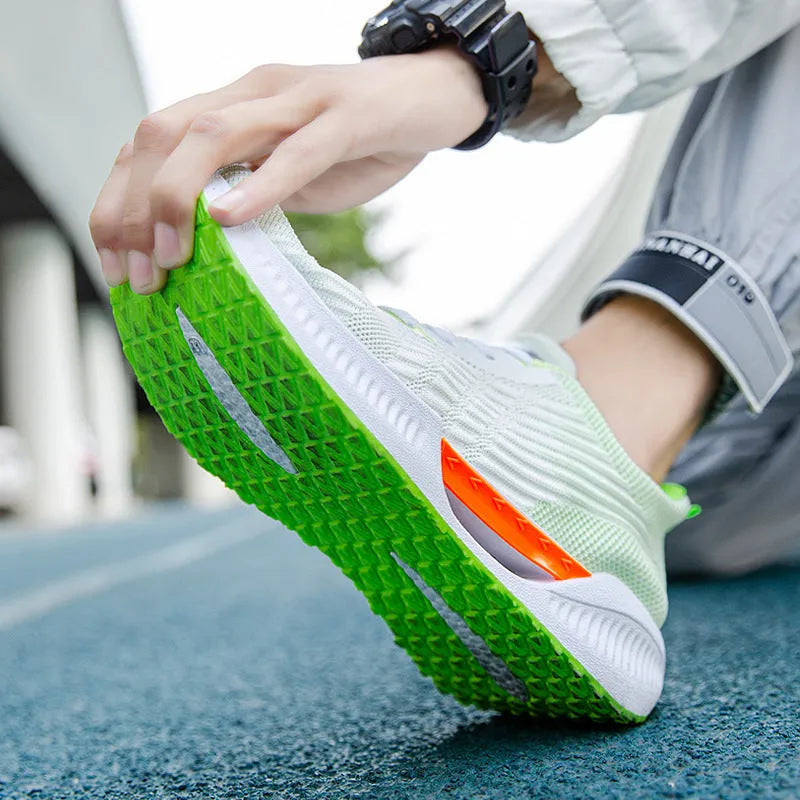 Men's blue mesh sports shoes with round toe and plastic sole on a grey background.