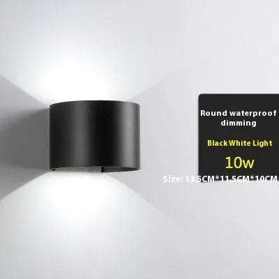 Satin black aluminium and glass LED wall lamp mounted on an interior wall.