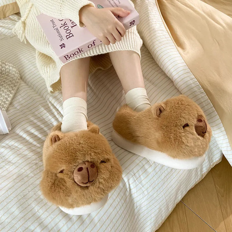 Light brown women's plush winter slippers with artificial wool lining and a PVC sole.