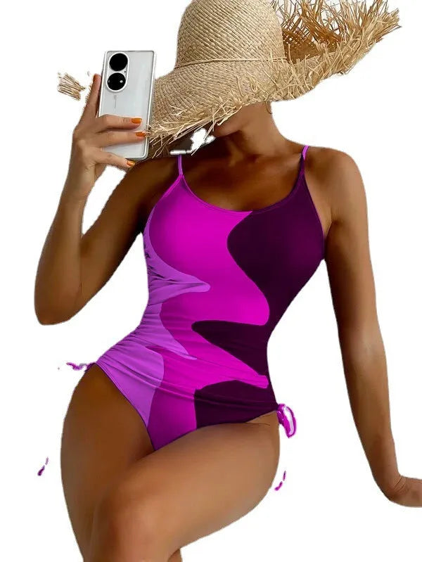 Women's sleeveless one-piece swimsuit in a striped print, showing backless design and available in multiple colours.