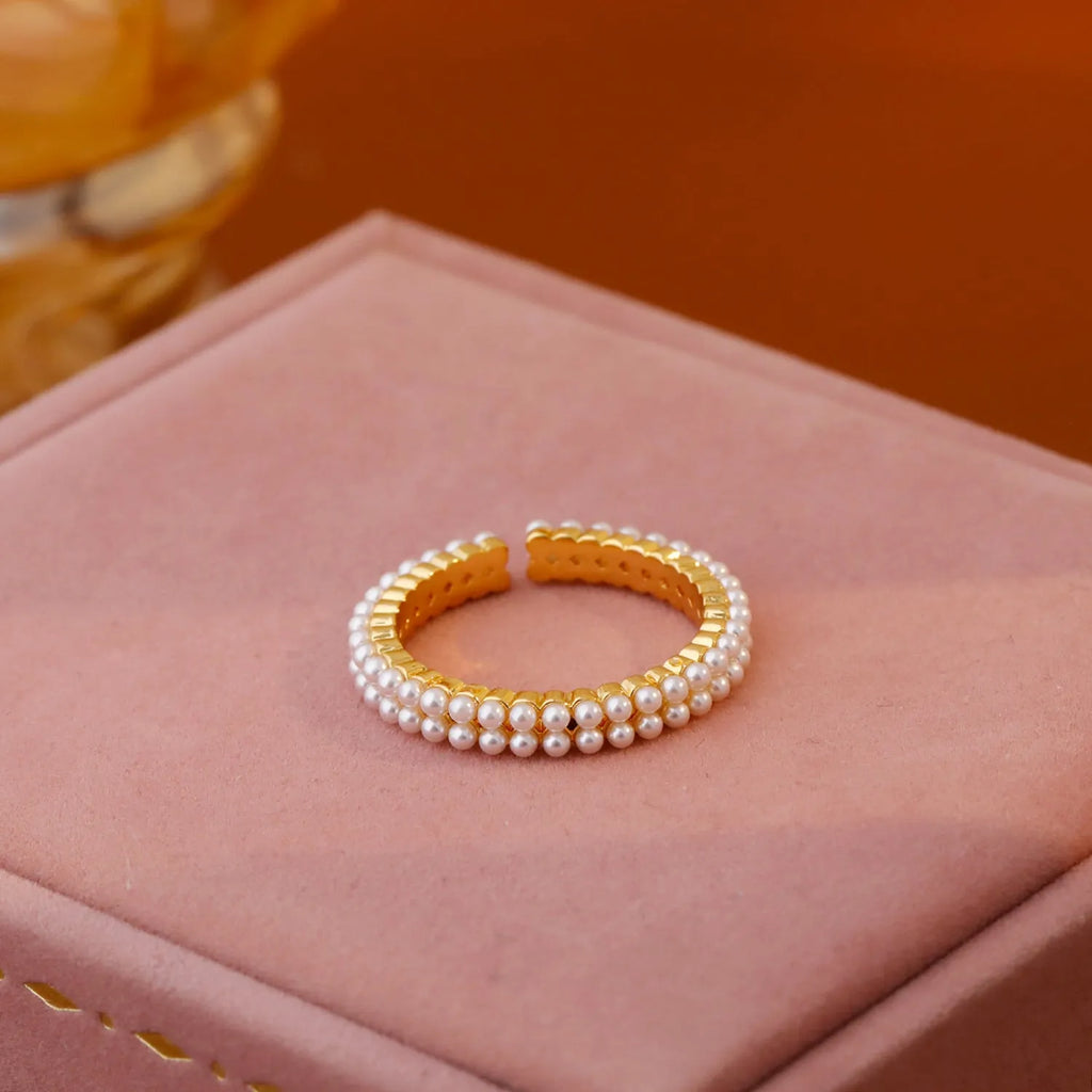 Geometric open mouth ring with electroplated gold finish and round pearl elements