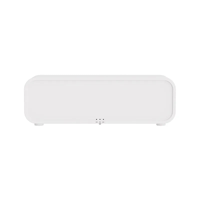 Black and white USB essential oil aroma diffuser with colour-changing light and remote control on a desk