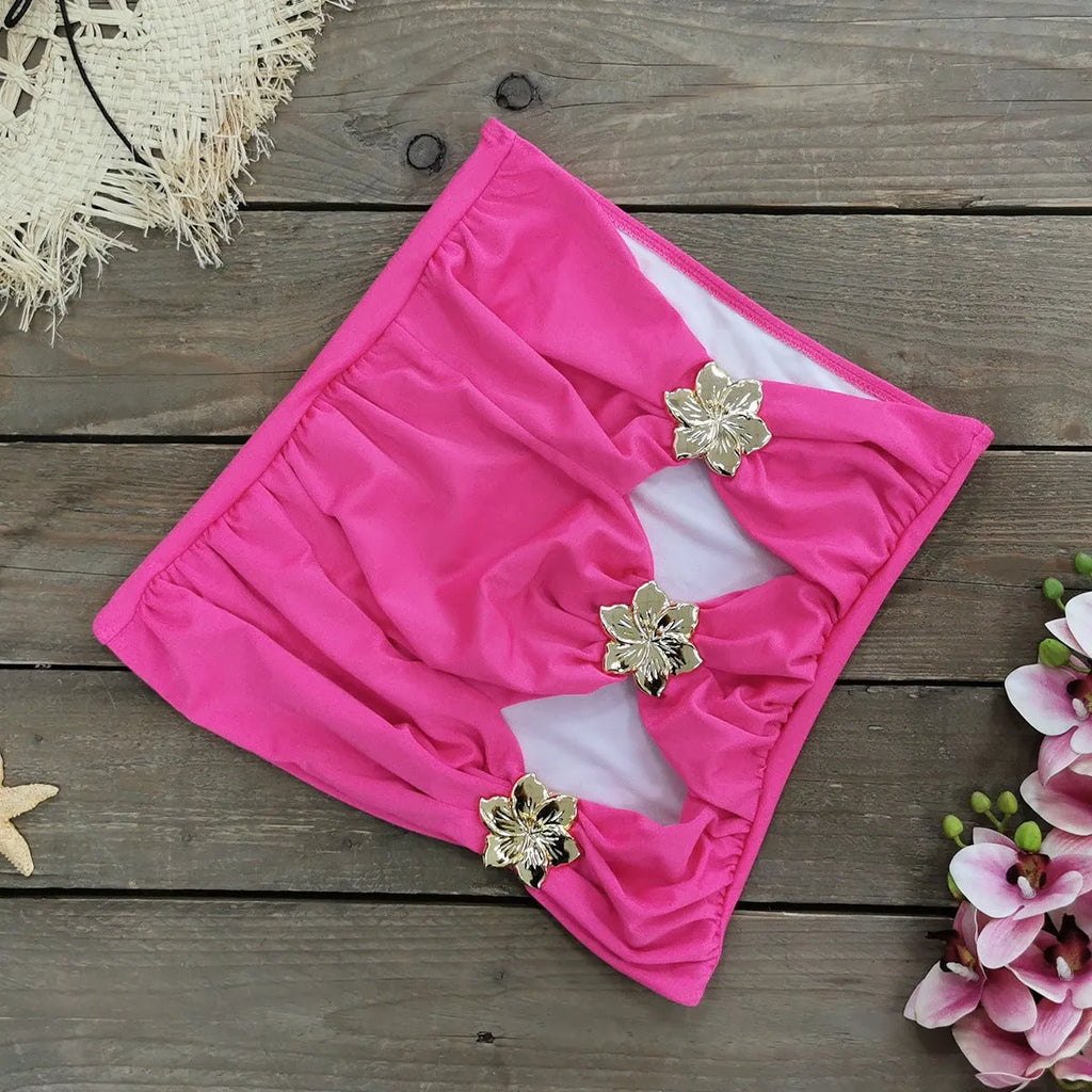 Women's solid colour one-piece swimsuit with a short skirt and hollow-out tube top design.