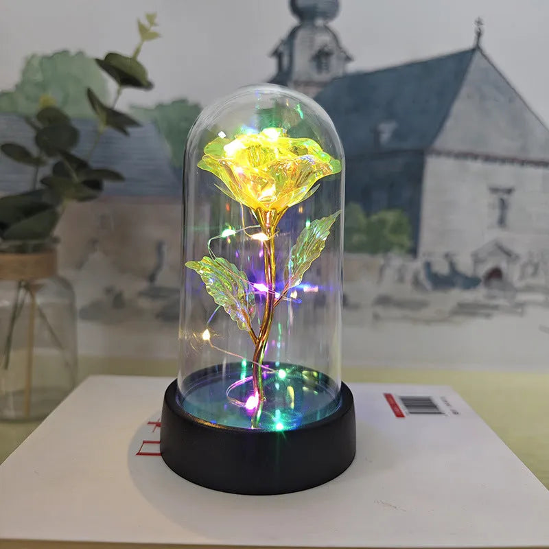 Small plastic night lamp with glass cover and flower decoration on black base