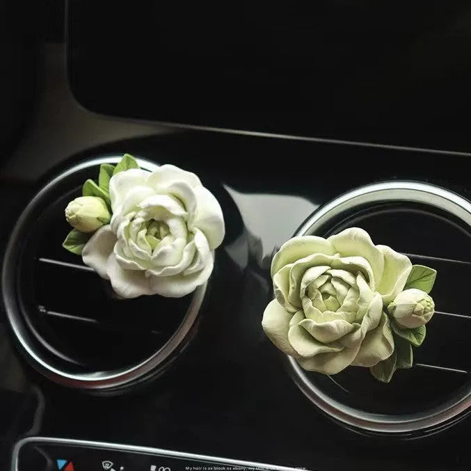 Jasmine scented solid gypsum car air vent diffuser in off white or green.