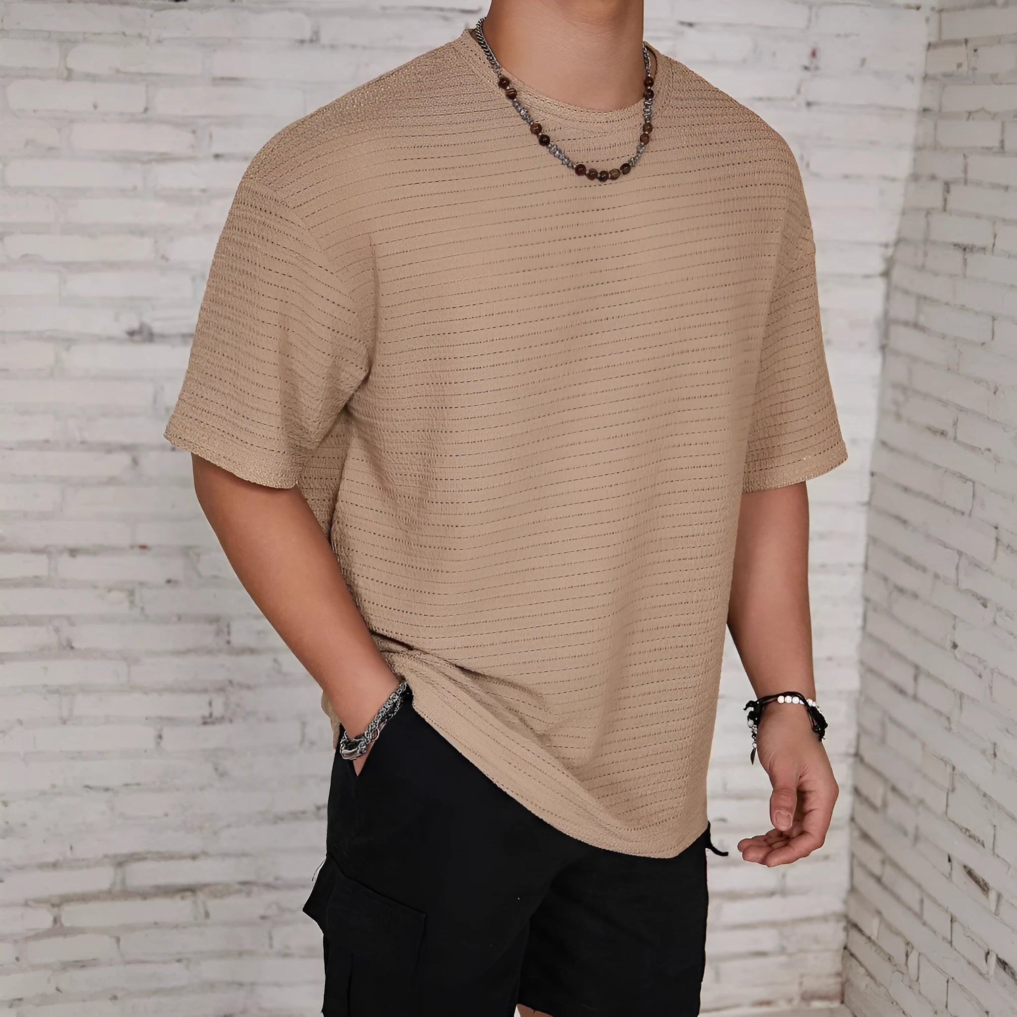 Men's loose fit light blue short sleeve round neck t-shirt on a hanger.