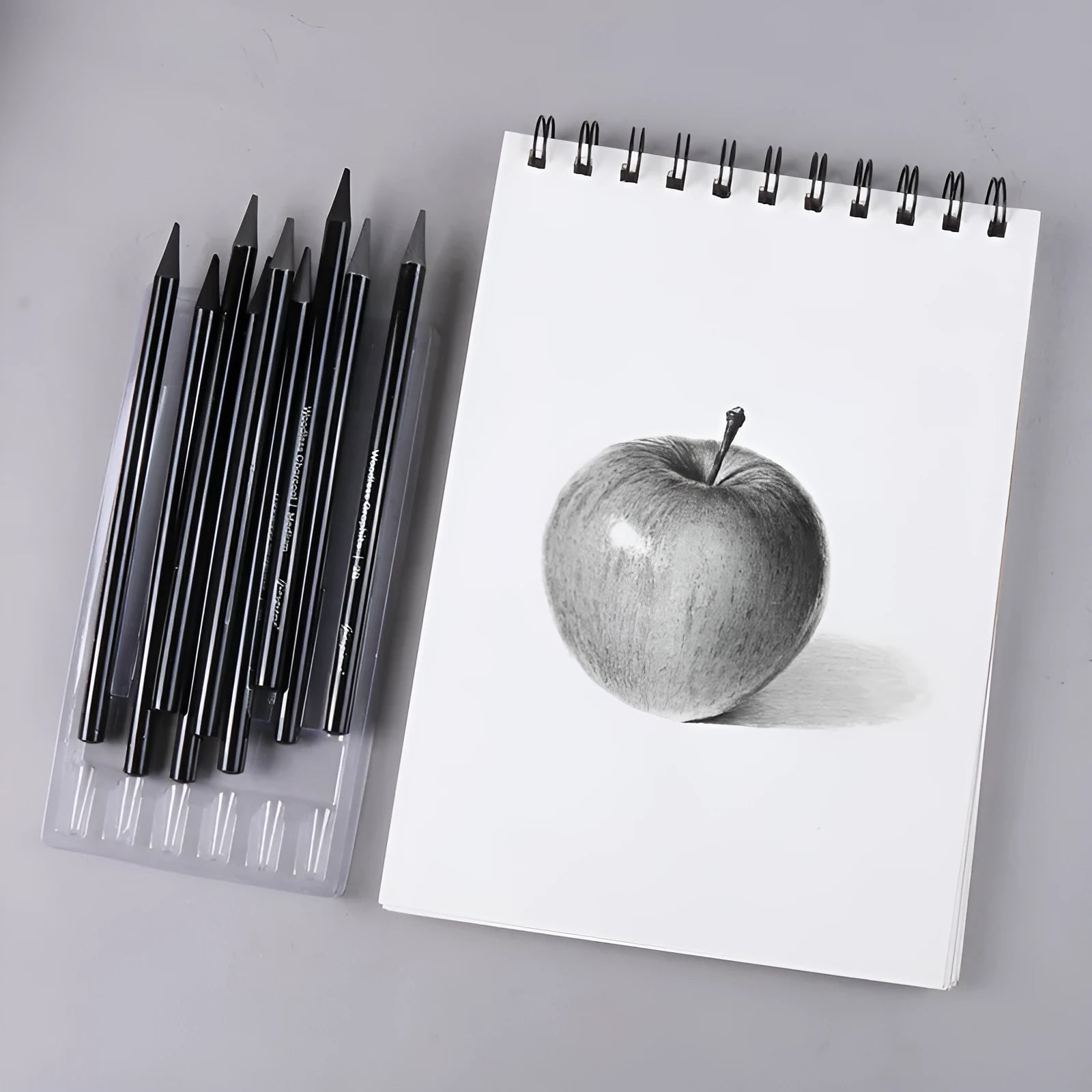 Carbonized Pencil Suit set showing graphite and carbonized pencils with wooden shells on a suction card.