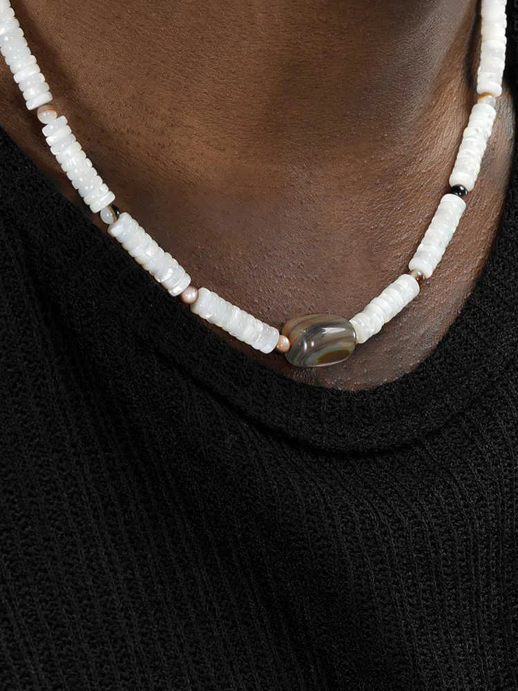 Men's vintage white shell necklace with round bead chain on neutral background