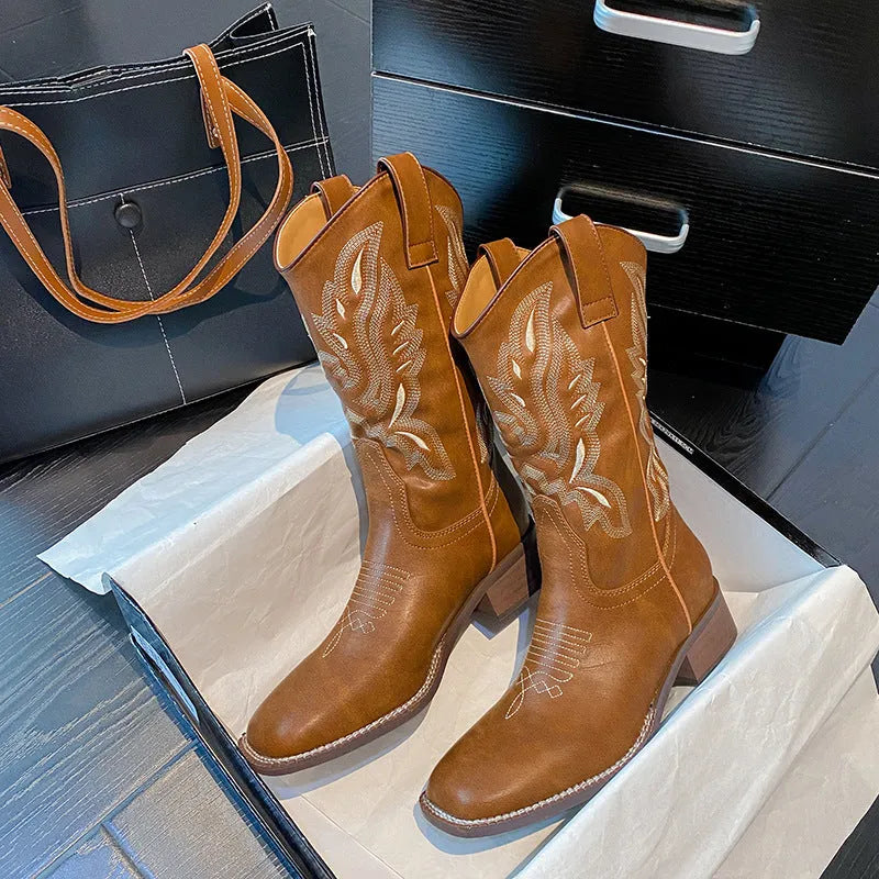 Brown women's mid-calf boots with embroidery detail, round toe, and low square heel.