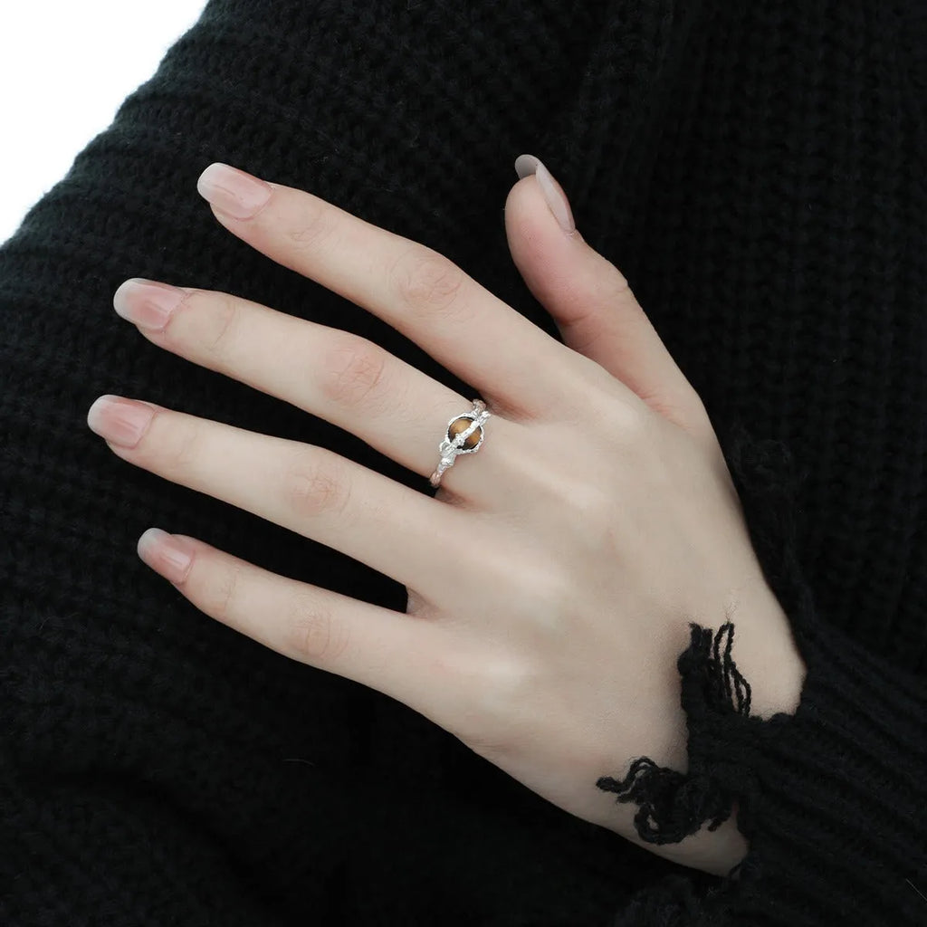 White gold coloured Saturn open ring with adjustable sizing on silver base