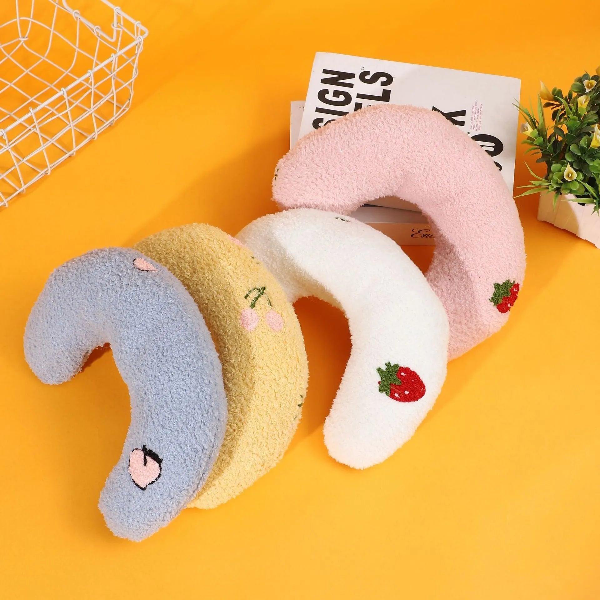 U-shaped half moon cloth pillow pet bed for cats in blue, pink, white, and yellow colours.