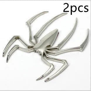 Three-dimensional metal spider bumper sticker in zinc alloy, shown in gold colour.