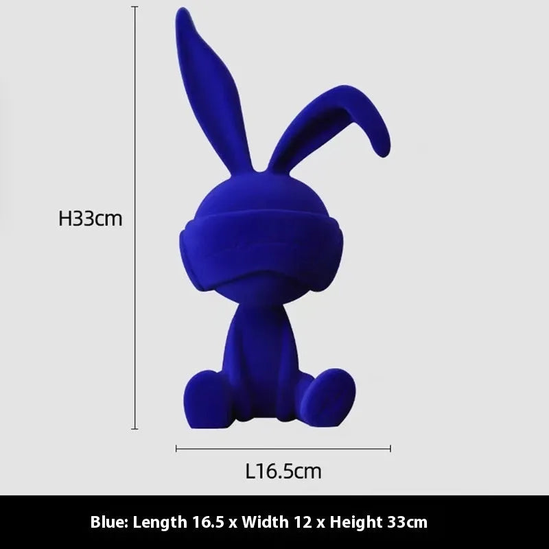 Small resin rabbit table ornament with a suede blindfold, shown in green, blue, and red colour options.