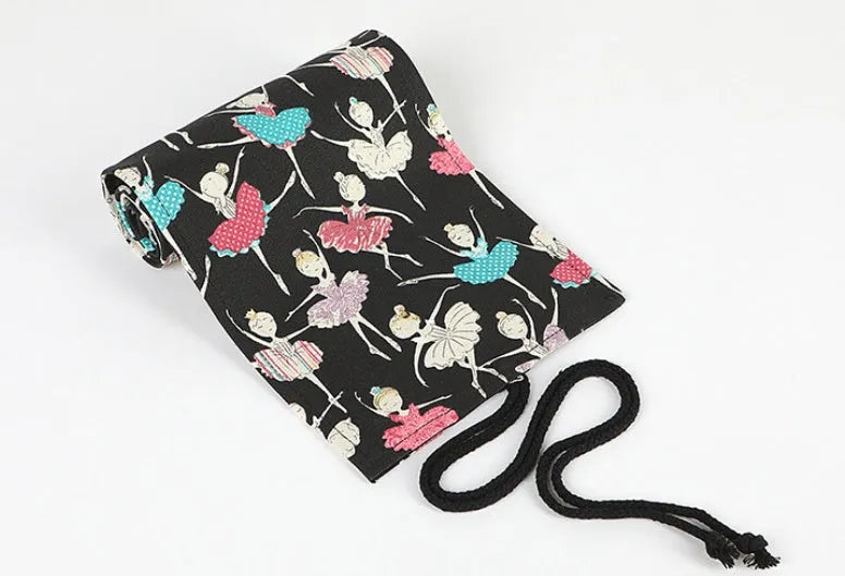Square canvas rolling pencil case with ballet girl print, showing interior holes for storing pencils.