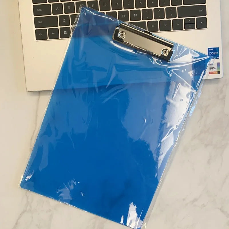 Transparent A4 writing board pad with metal clip holding paper, shown in blue colour variant.