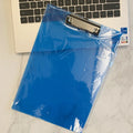 Transparent A4 writing board pad with metal clip holding paper, shown in blue colour variant.