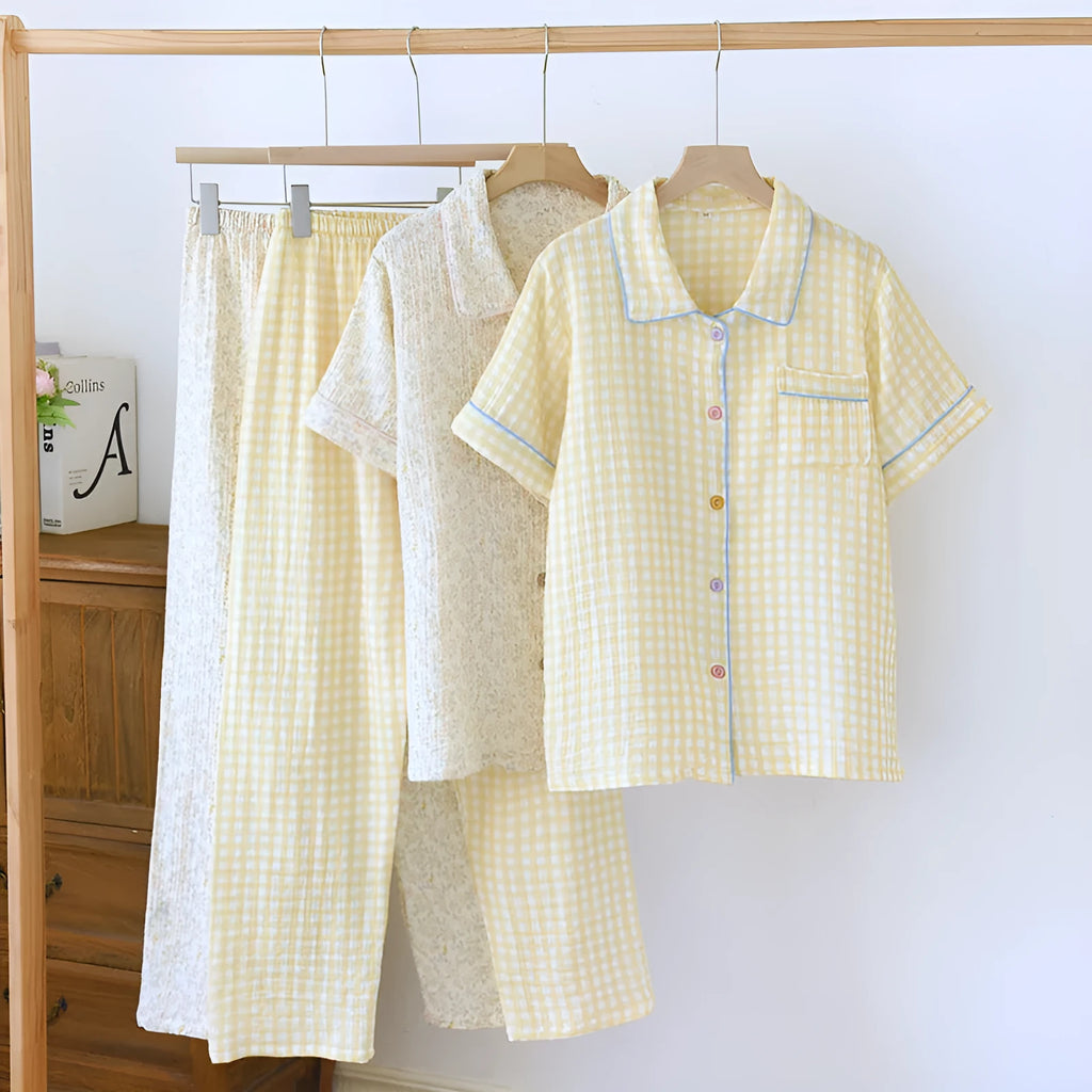 Women's loose-fit yellow plaid cotton gauze short-sleeve top and trouser set on a hanger.