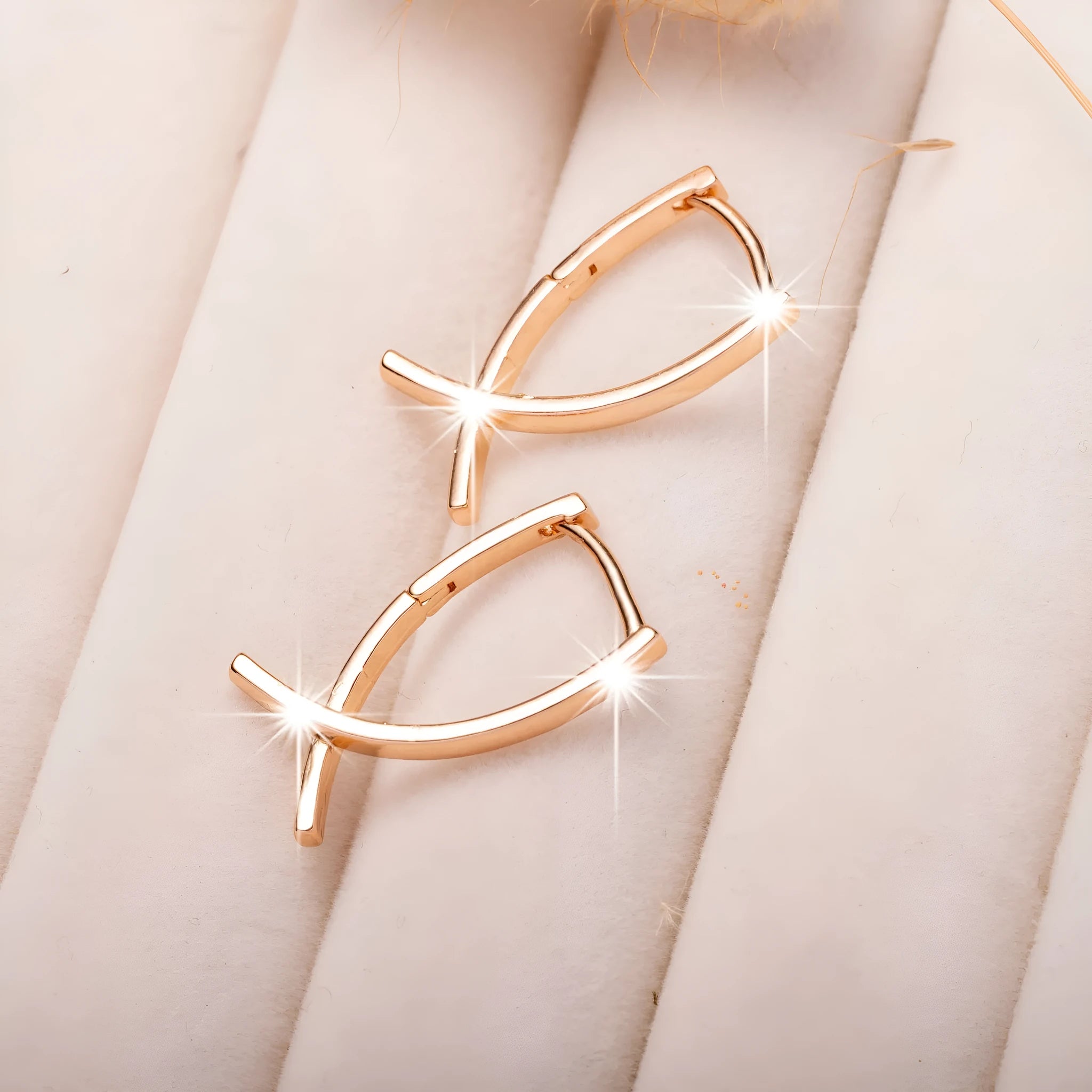 Rose gold cross shaped earrings with polished finish on copper construction