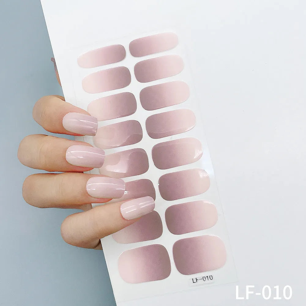 Set of 16 solid colour nail art stickers showing floral, geometric, and pattern designs for manicure application