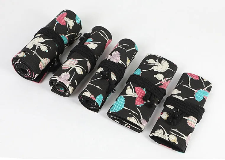 Square canvas rolling pencil case with ballet girl print, showing interior holes for storing pencils.