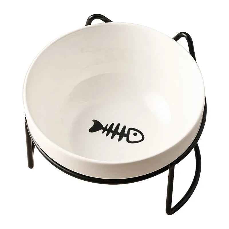 White ceramic cat bowl with decorative pattern sitting in a black iron frame stand.