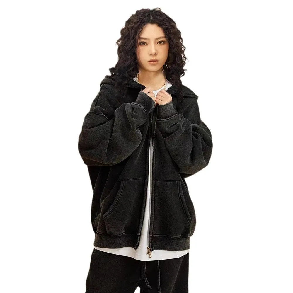 Man wearing a washed black fleece-lined cotton hooded cardigan with a double zipper.