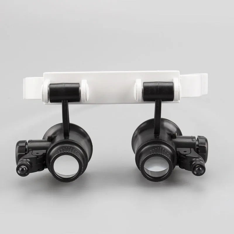 White head mounted magnifying glass with adjustable band and built-in LED light for close-up repair work