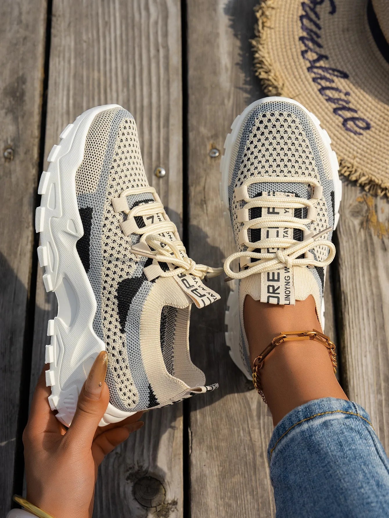 Women's Flyknit mesh lace-up sneakers in a grey colourway with a round toe and flat rubber sole.