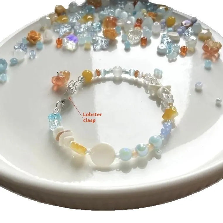 Orange diamond-shaped women's bracelet with round details on a mixed material and alloy band.