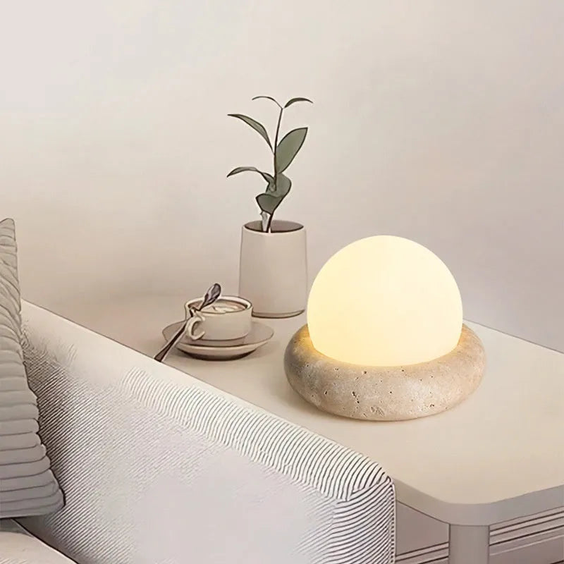 Cream-coloured modern bedside night lamp with remote control on wooden table