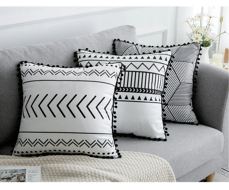 Bohemian patterned pillow cover in light gray on a living room sofa with decorative throw