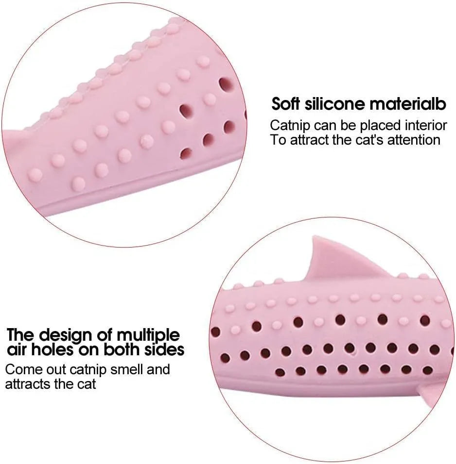 Green silicone fish-shaped cat chew toy with breathable side holes on wooden floor