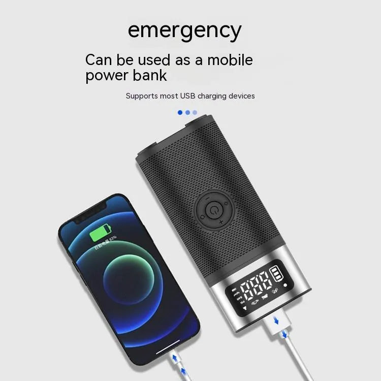 Black portable wireless smart air pump with display, charging cable and nozzle attachments on a dark surface.