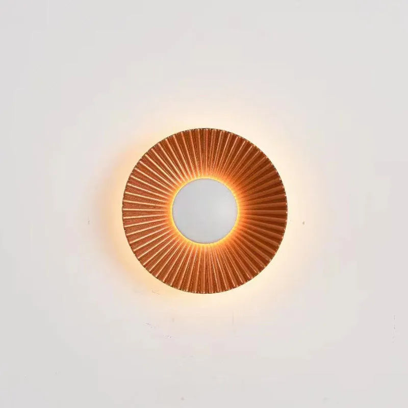 Round aluminium wall lamp mounted on a wall, showing a white and gold two-tone finish.