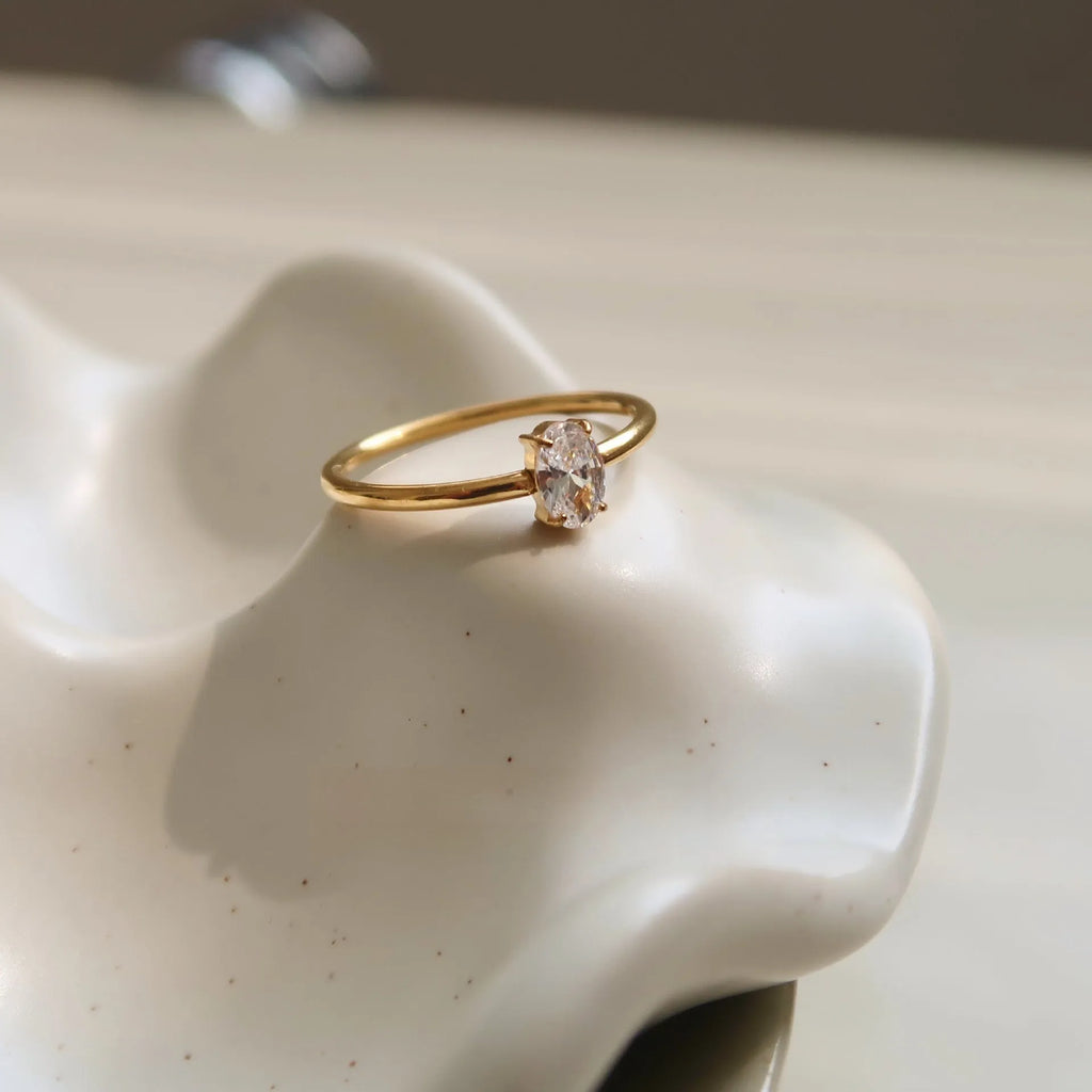 Golden stainless steel ring showing heart and oval love symbol designs with size options from 5 to 8