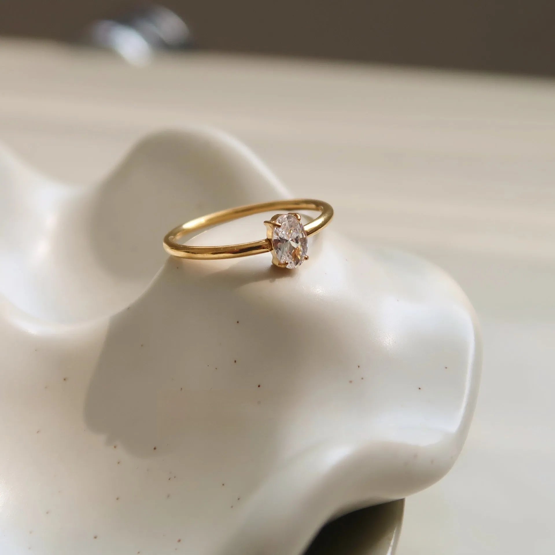 Golden stainless steel ring showing heart and oval love symbol designs with size options from 5 to 8