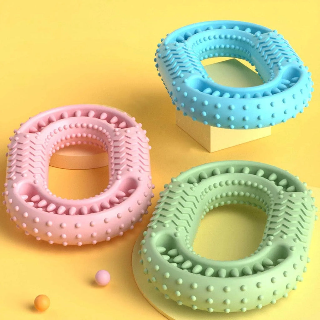Blue, green, and pink O-ring shaped durable dog chew toy for aggressive chewers.