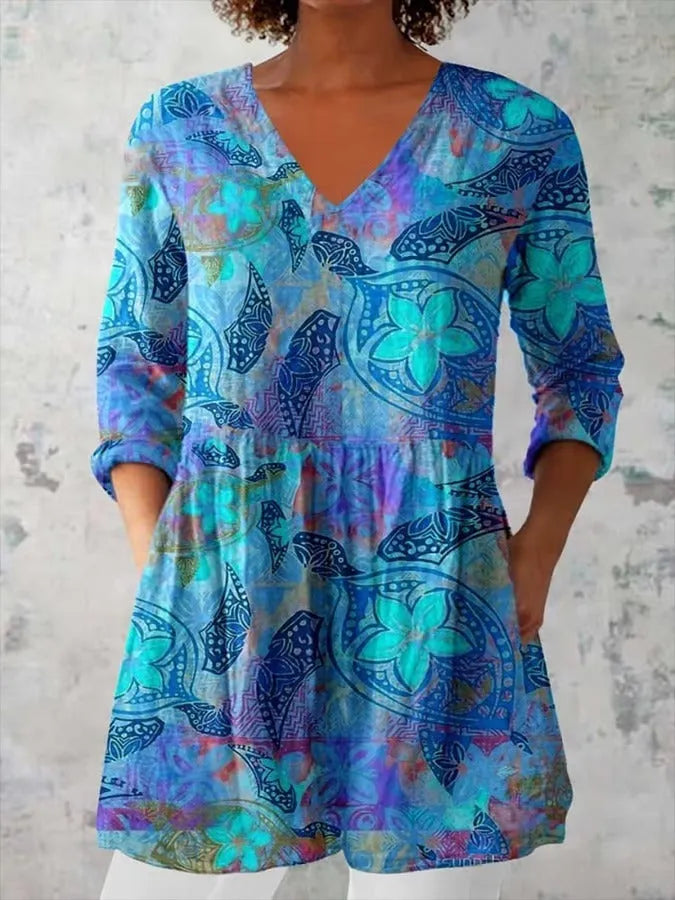 Women's slim-fit retro printed long-sleeved polyester top on a hanger, showing detail of digital print.
