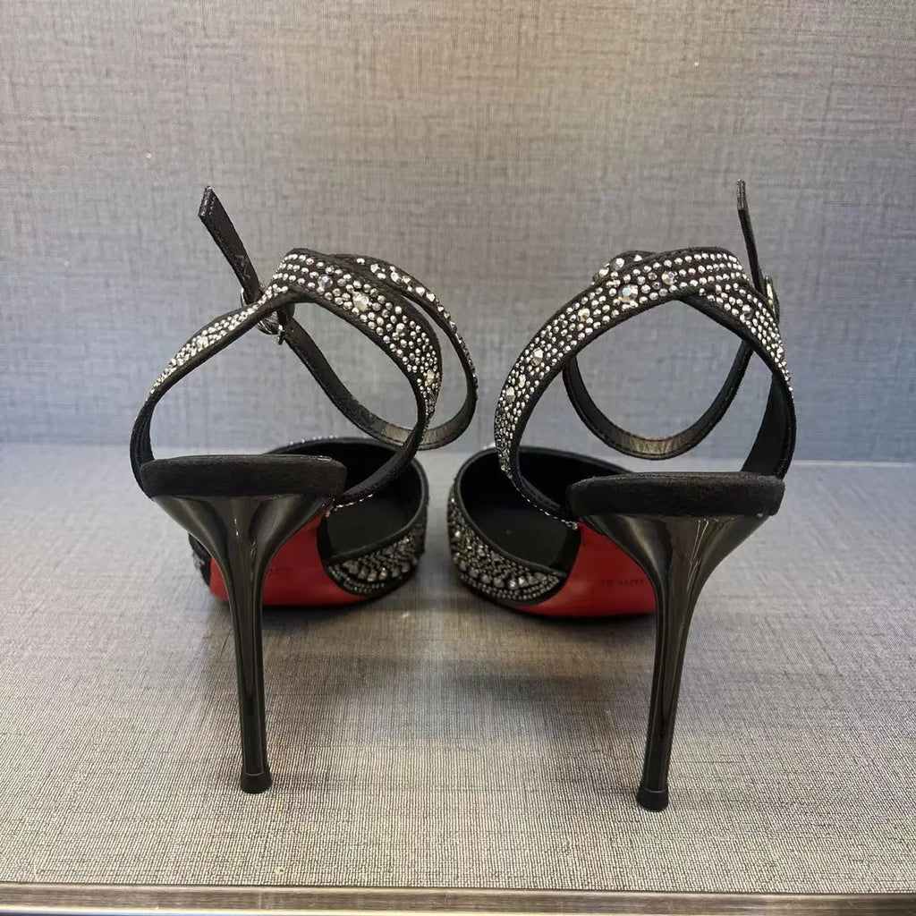 Women's black hollow high heels with red sole and pointed toe on a stiletto heel