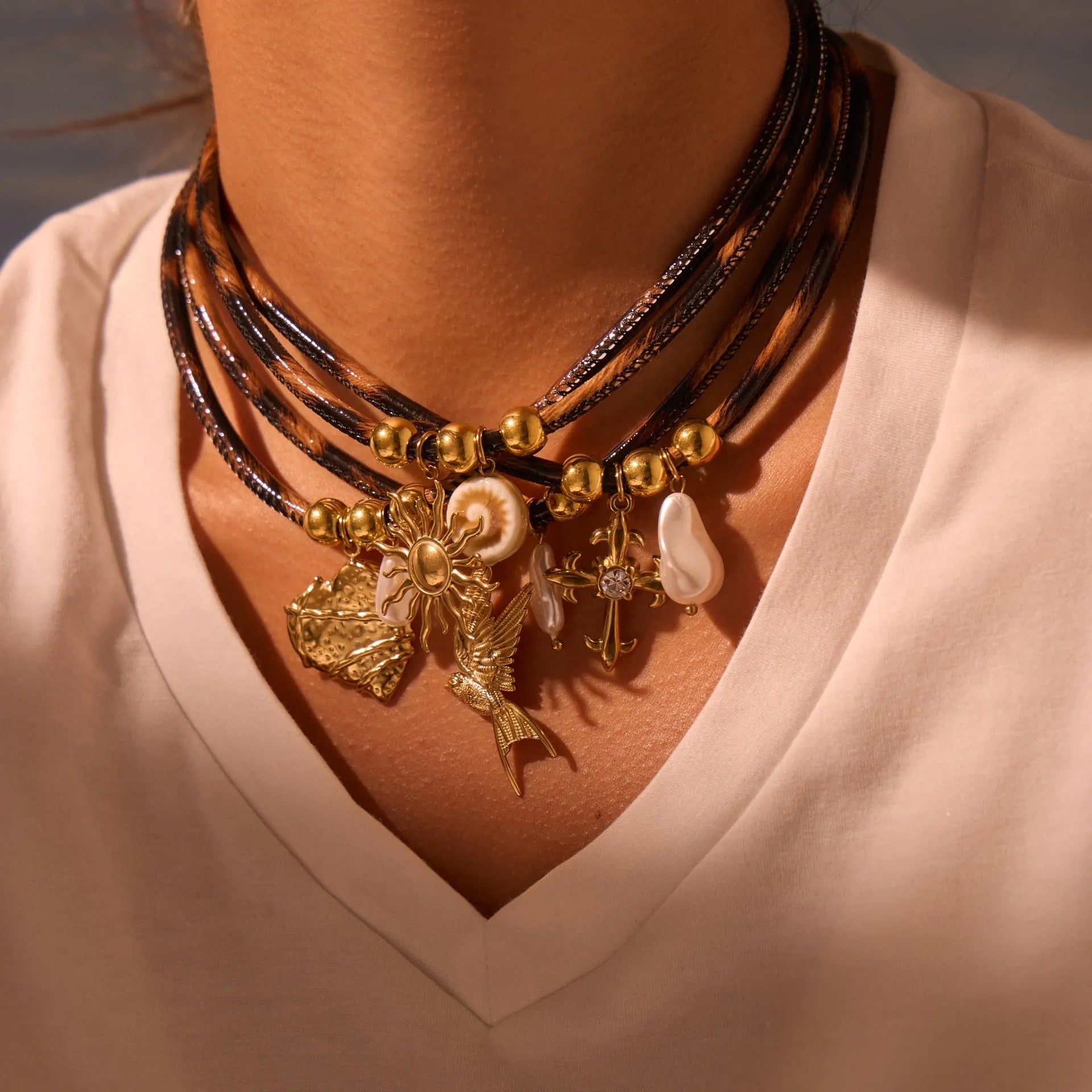Geometric leopard print pendant on a stainless steel necklace chain with gold electroplated finish.