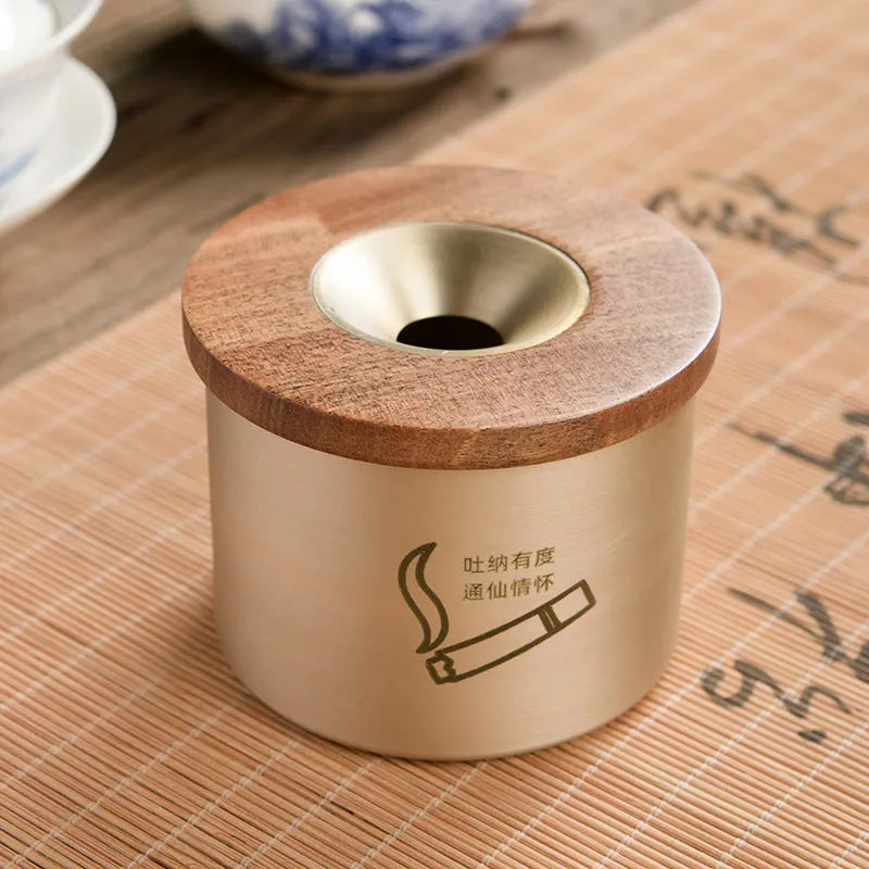 Retro brass ashtray with wooden lid showing copper construction and central hole design