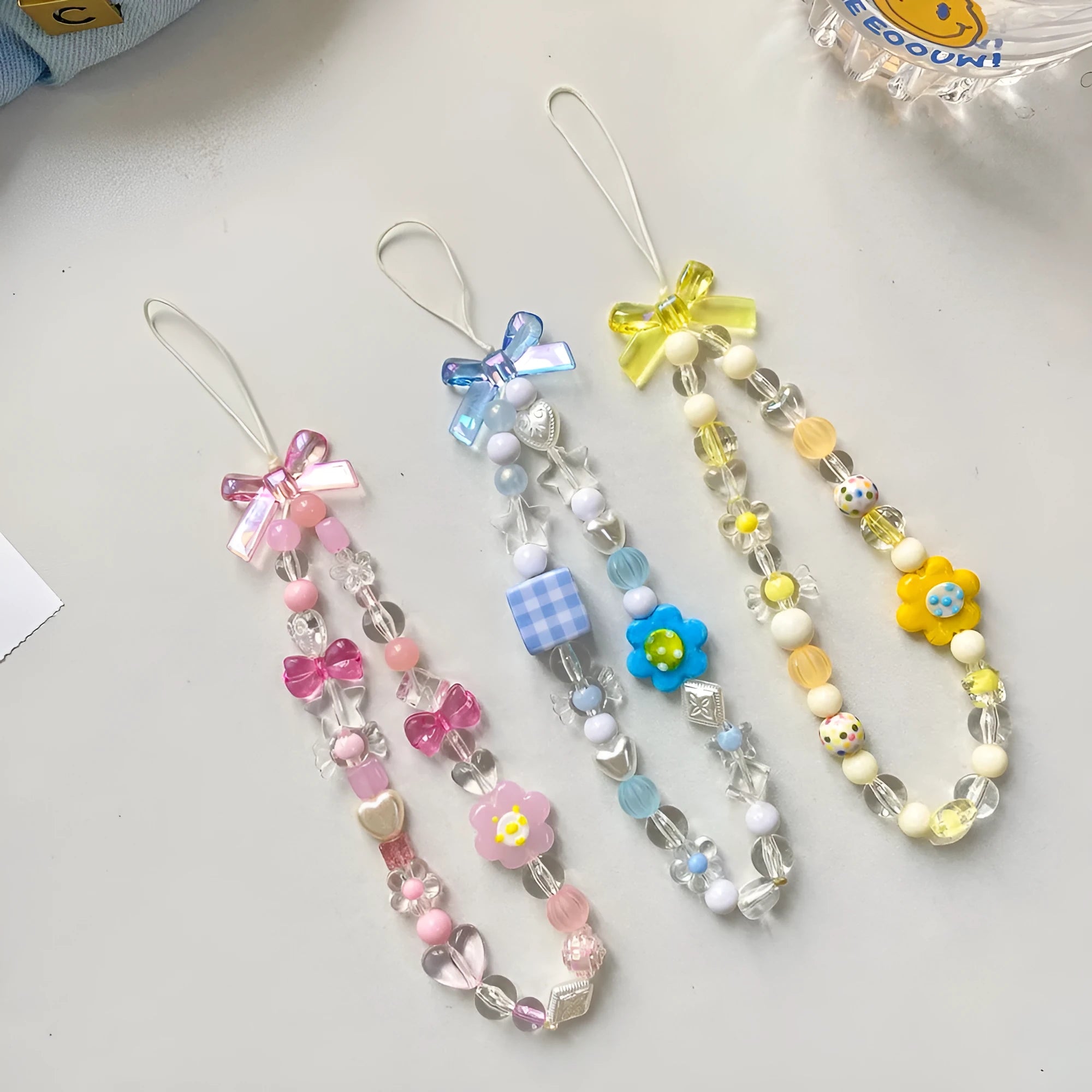 Colourful beaded flower mobile phone lanyard with hand rope and decorative floral elements