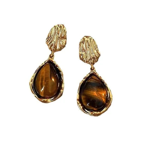 Handmade geometric earring set showing three styles: round piece, irregular amber, and water drop tigereye studs with tassels.