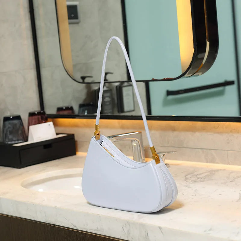 Women's oval shaped underarm bag in PU leather with single shoulder strap and internal zipper compartment