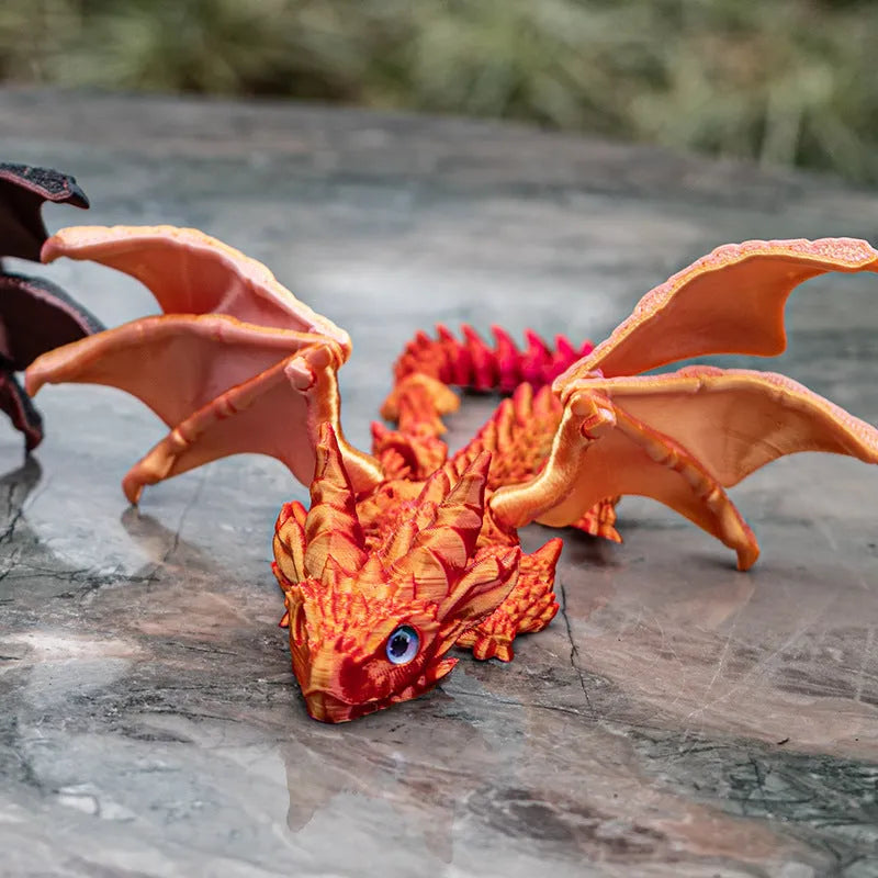 Red and gold 3D printed dragon wings toy decoration on a white background.