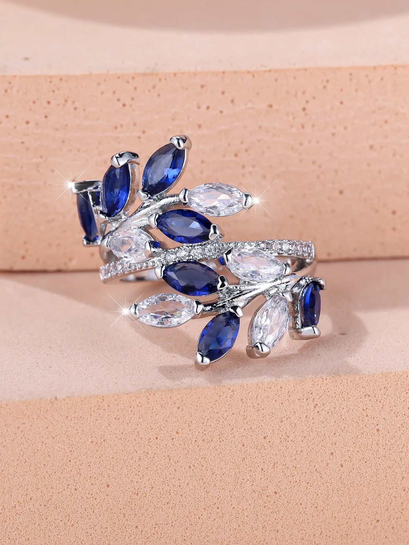Adjustable horse eye zircon leaf ring in copper on a hand, showing leaf detail and colour options.