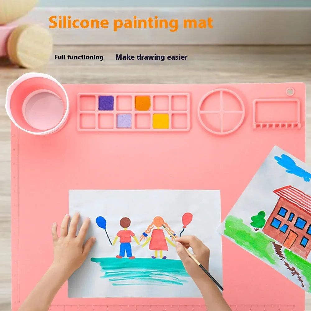Light blue silicone painting mat with two round bowl compartments, measuring 50 by 40 cm.