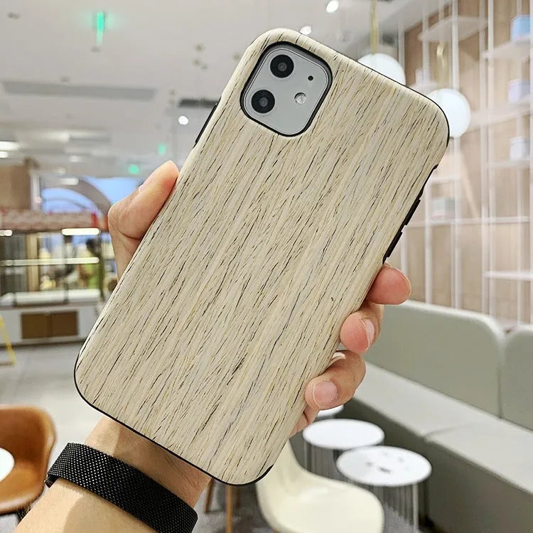 Natural wood grain iPhone back cover case in rosewood finish next to an iPhone